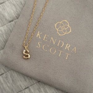 Kendra Scott “S” gold necklace. Never worn. Original bag in tact.